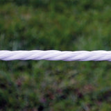 white patriot electric fence polirope with green grass background 