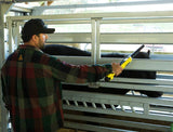 Cattle rancher using a Tru-Test SRS2 Electronic Identification (EID) Stick Reader  on cattle to get livestock information at farm